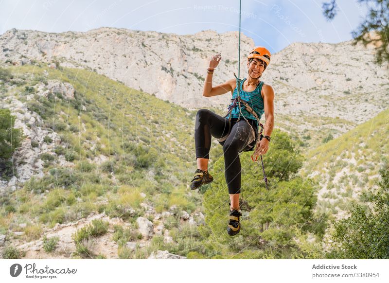 Glückliche junge Bergsteigerin geniesst das Bergsteigen Aufsteiger genießen Frau Alpinist hängen Klippe aufsteigen Berge u. Gebirge Gelände Abenteuer extrem