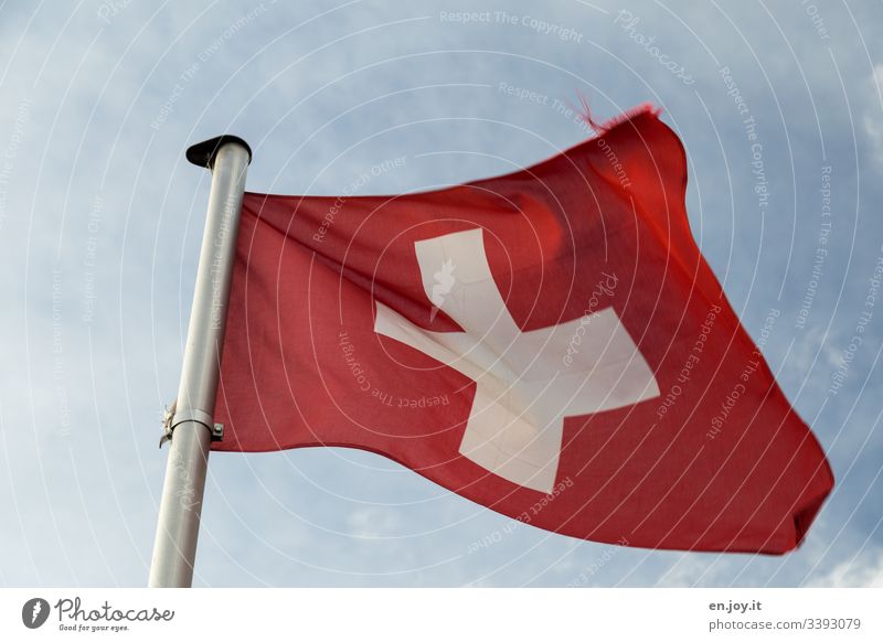 Schweizerfahne vor bewölktem Himmel Wolken Fahne Rot Kreuz Weiß Wehen Mast Fahnenmast Wind