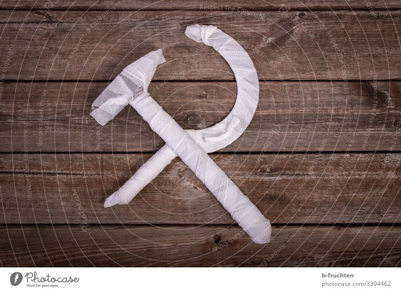 Hammer und Sichel einbandagiert auf Holzbrettern bandagieren Erste Hilfe symbol Rettung Kommunismus Politik & Staat Verband Hülle eingehüllt Schutz weiß