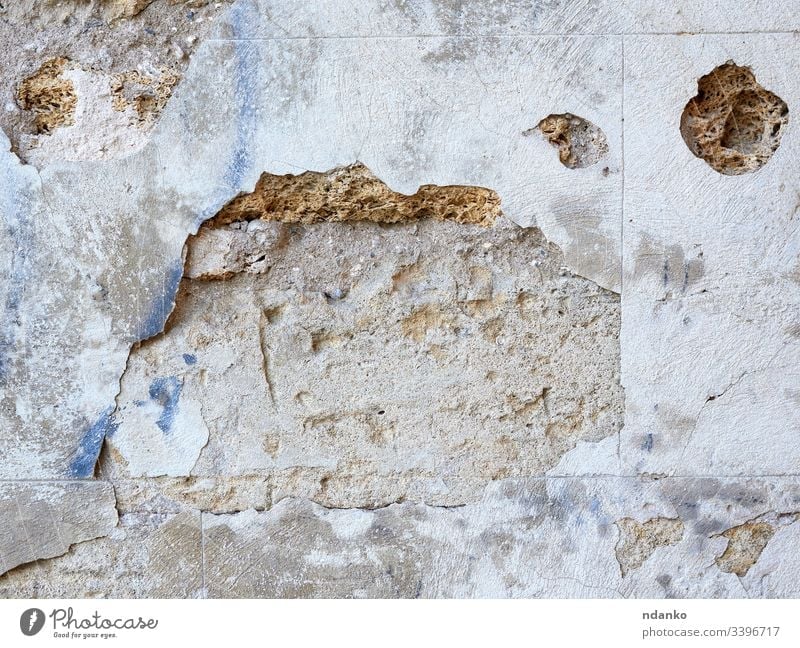 Mauer aus gelben rechteckigen Steinen mit Zement, Fragment antiker Architektur abstrakt gealtert Alterung Antiquität Hintergrund Klotz Baustein Mauerwerk hell