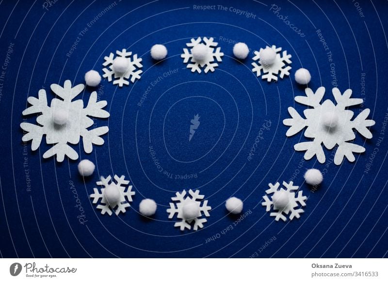 Weihnachtskomposition. Muster aus Schneeflocken auf blauem Hintergrund. Weihnachts-, Winter- und Neujahrskonzept. Flachlegung, Draufsicht, Kopierraum oben Kunst