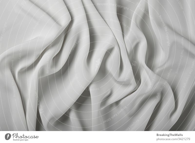 Hintergrund aus weißen Textilfalten Gewebe Pferch Plisseefalte Zopf grau abstrakt einklemmen Bügelfalte Textur Nahaufnahme Stoff Farbe Industrie erhöht Top