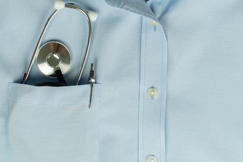 Gesundheitsfürsorge des globalen Virenausbruchs, Stethoskop in der Hemdtasche des Arztes Hintergrund blau Business Pflege prüfen Klinik klinisch Nahaufnahme