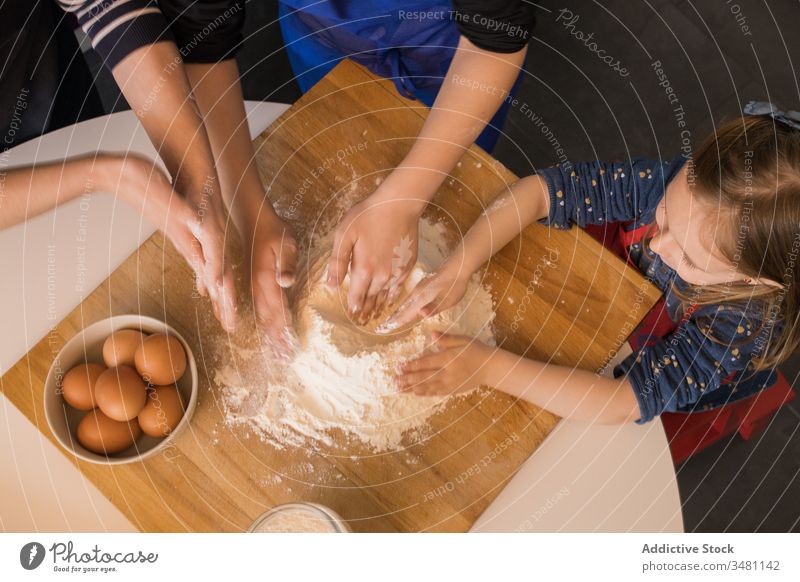 Kinder bereiten gemeinsam Teig zu Küche Koch Teigwaren Mehl Zusammensein Tisch vorbereiten Lebensmittel Schürze niedlich Bestandteil Spätzle Hilfsbereitschaft
