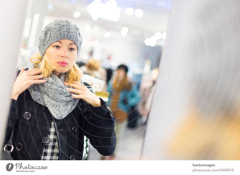 Schöne Frau beim Einkaufen im Bekleidungsgeschäft. Laden Sale Kleidung Käufer Kunde Mädchen Verbraucher Erwachsener jung schön Mode Kaufhof Einzelhandel