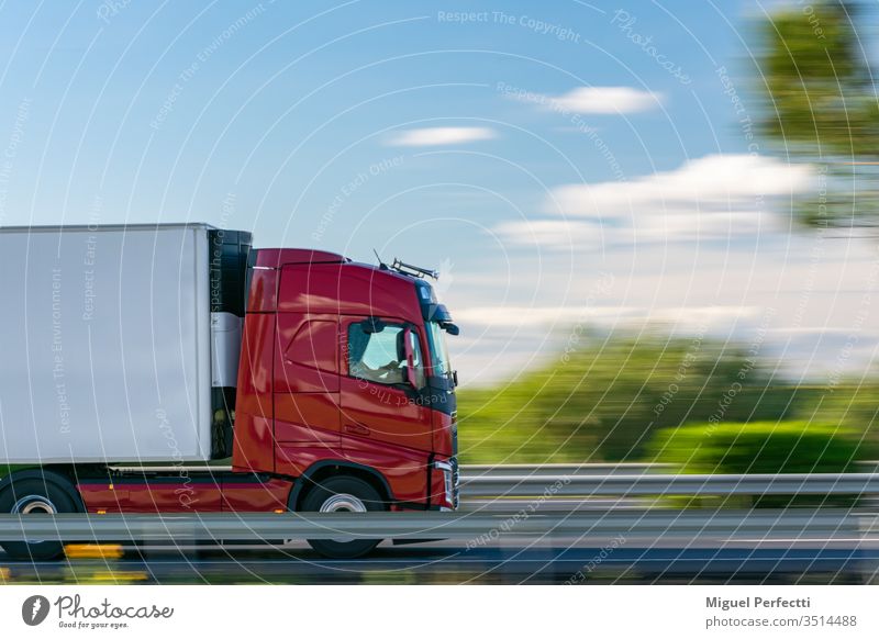 Lastwagen mit Kühlsattelanhänger fährt auf der Autobahn bei blauem Himmel mit einigen Wolken Anhänger kontrollierte Temperatur gekühlt Ladung bewegend