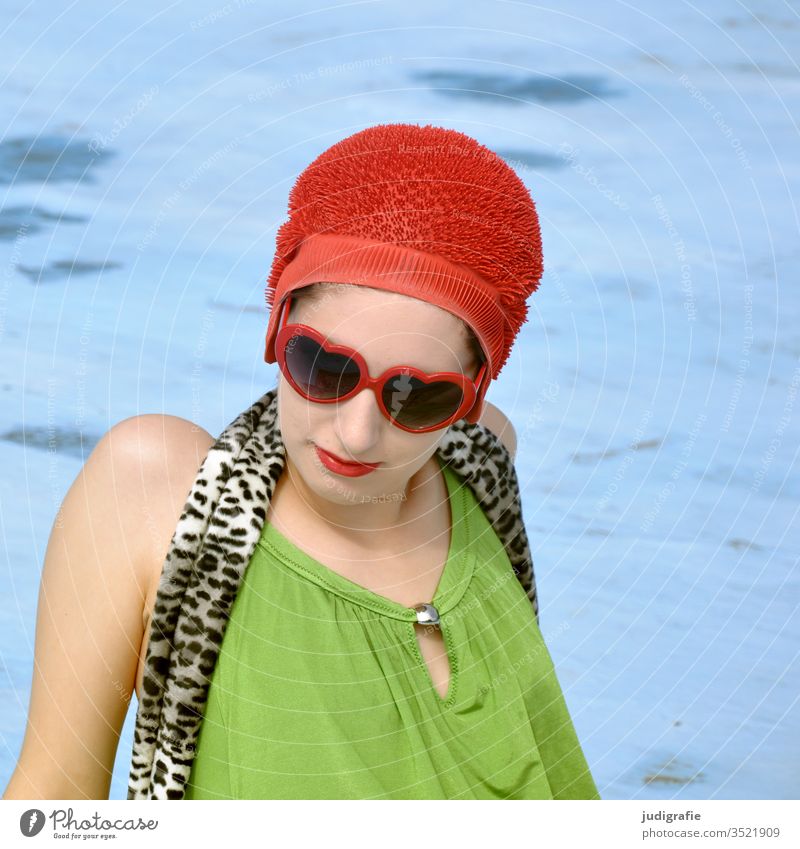 Das Mädchen mit der schönen roten Badekappe und grünem Badeanzug sonnt sich im leeren Nichtschwimmerbecken. Eine Sommerliebe. Frau Badebekleidung Badehaube Haut