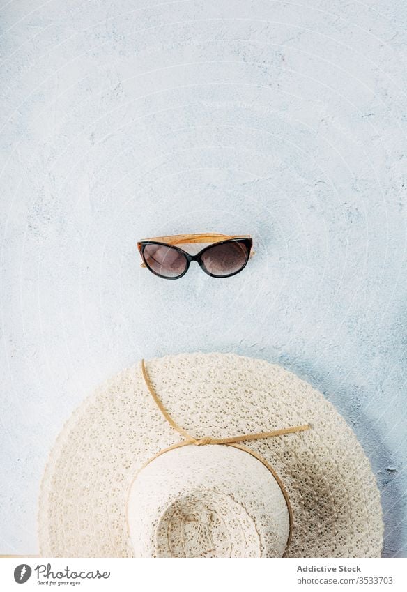 Sonnenbrille und Hut auf Stuckoberfläche Sommer Urlaub Stil Accessoire Oberfläche Strand Zusammensetzung trendy Mode verputzen reisen Tourismus Ausflug Reise