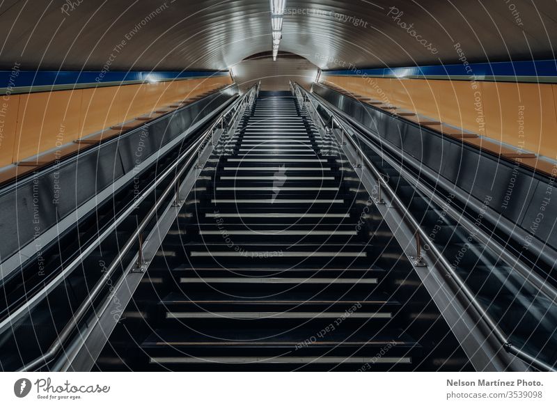 Eine Treppe von der U-Bahn-Station führt zur Straße hinauf, die bei covid19 leer steht. Zug Linien Formen allein nach oben Leerraum elektrische Treppe COVID19