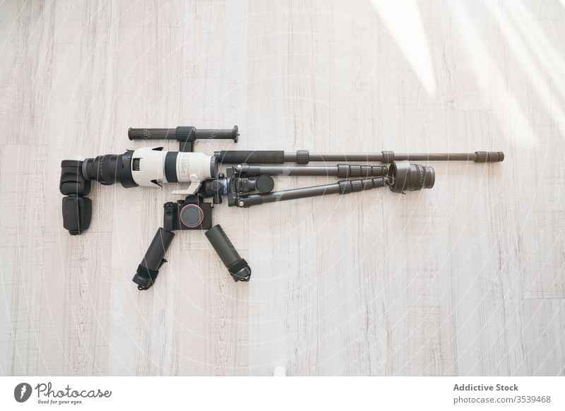 Professionelles Zubehör für auf dem Boden liegende Fotokamera in Form eines Jagdgewehrs Fotoapparat Gerät Zusammensetzung Scharfschütze Konzept professionell