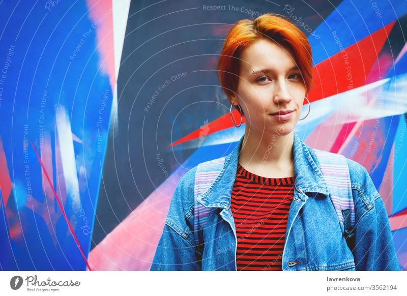 Junge erwachsene weiße Frau in Jeansjacke mit abgestorbenen roten Haaren, Lifestyle-Porträt mit selektivem Fokus Erwachsener attraktiv lässig Kaukasier gefärbt
