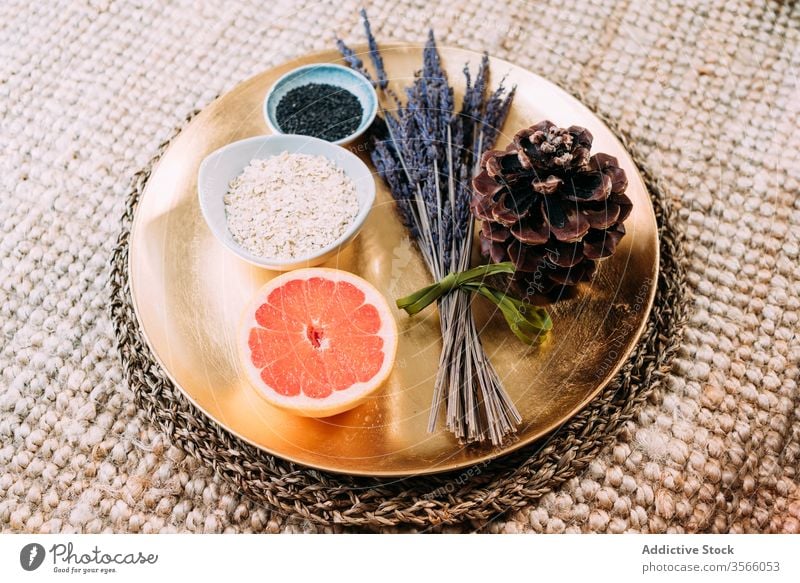 Duftende Bio-Produkte auf goldenem Tablett Supernahrung Antioxidans duftig Grapefruit Lavendel Fichtenzapfen Chia Sesam natürlich organisch Vitamin Gesundheit