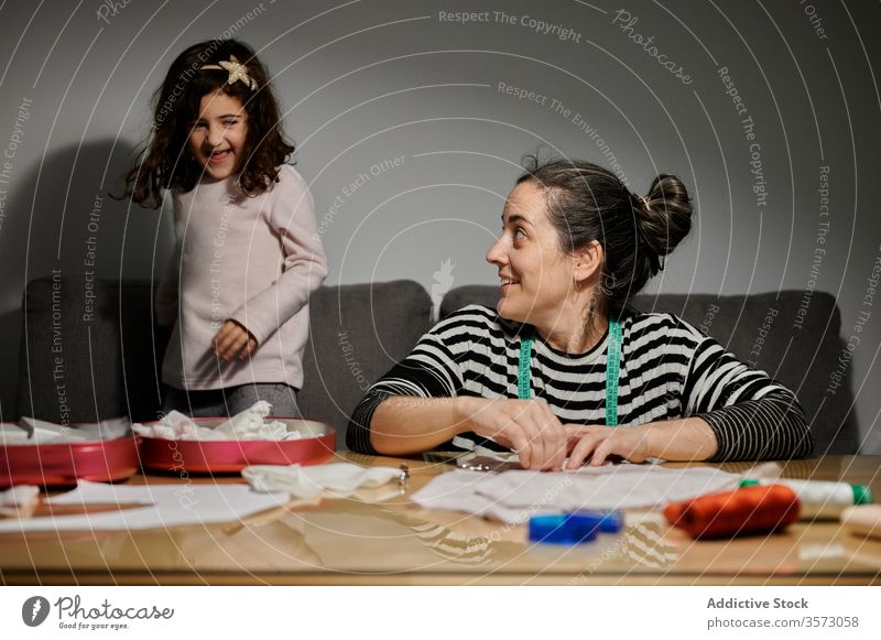 Kreative Mutter bringt Tochter zu Hause das Nähen bei nähen kreativ heimwärts Näherin Hobby zeigen Kind Eltern Gewebe Schere geschnitten Handwerk Tisch Kleid