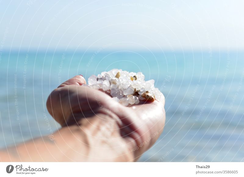 Salz vom Toten Meer natürliche Mineralienbildung am Toten Meer in Frauenhand Pflege Gesundheit Spa Hand Schönheit Behandlung Hintergrund weiß Ansicht Salon