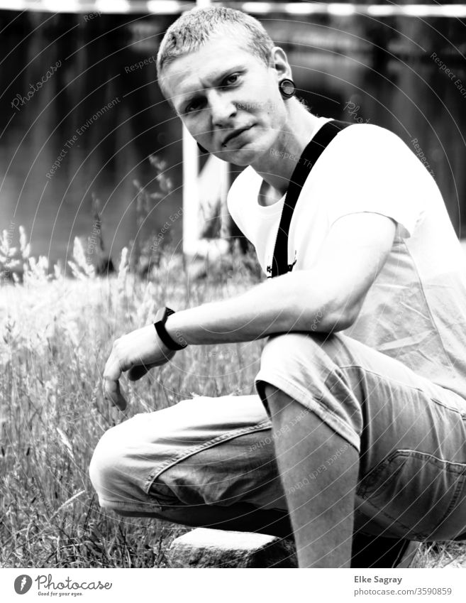 Junger  Mann im Gras Junger Mann Jugendliche 18-30 Jahre maskulin Schwarzweißfoto Außenaufnahme Porträt