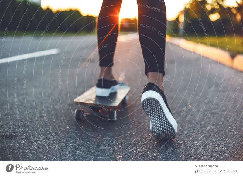 junge Skateboardfahrer mit den Beinen auf dem Skateboard Skateboarderin Mädchen Schuhe Turnschuh Frau extrem Jugend gelb Sonnenschein Sport Skateboarding USA