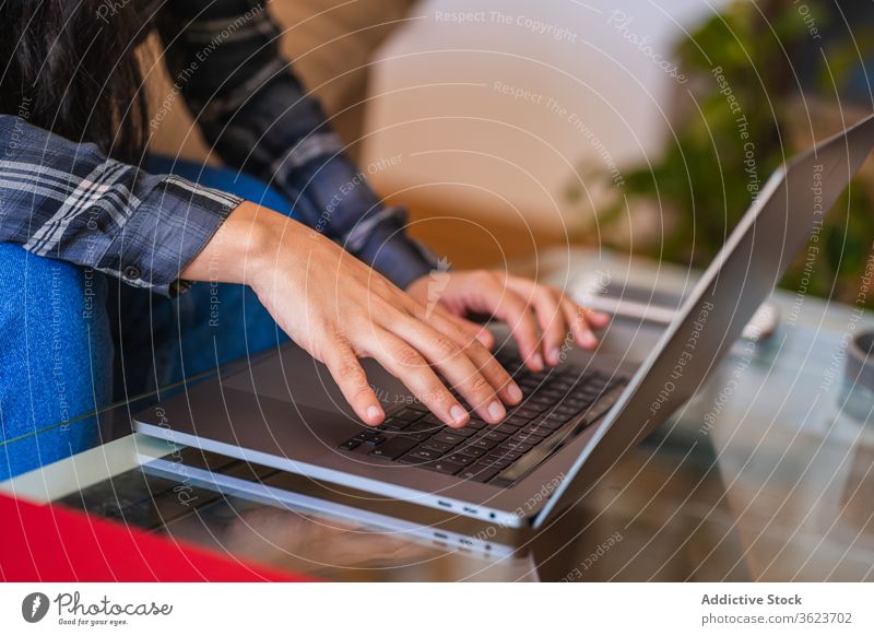Junge Frau arbeitet mit Laptop im Wohnzimmer heimwärts benutzend Arbeit freiberuflich Sofa jung lässig abgelegen Gerät Apparatur Browsen Internet Lifestyle