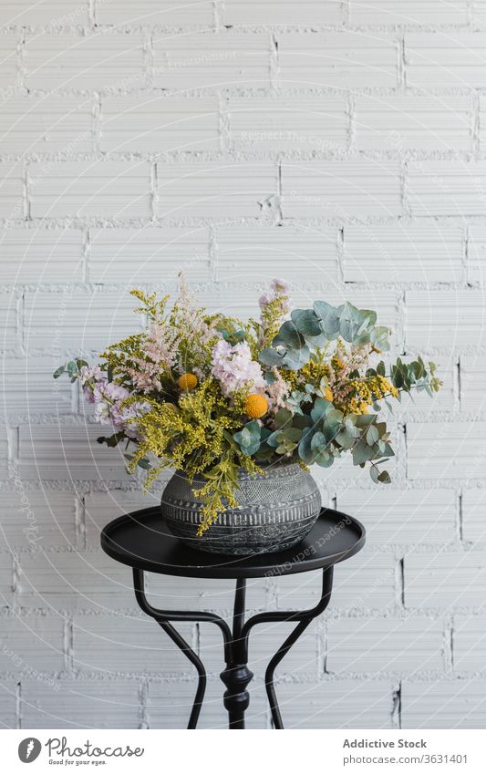 Keramische Vase mit bunten Blumen auf dem Tisch Blumenstrauß Floristik frisch natürlich farbenfroh verschiedene Topf kreativ schön Eukalyptus Goldrute Craspedia