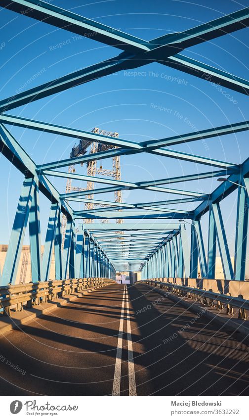 Moderne Straßenbrücke im Industriegebiet bei Sonnenuntergang. Brücke Großstadt blau Verkehr industriell Kranich Metall Asphalt Träger Rahmen Maschinenbau