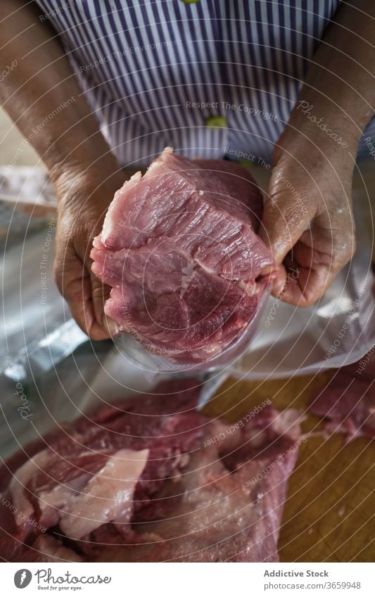Getreideschlachter, der frisch geschnittenes Schweinefleisch sortiert Person Rudel Fleisch Fabrik vorbereiten Lebensmittel Metzger Arbeit Job organisch roh