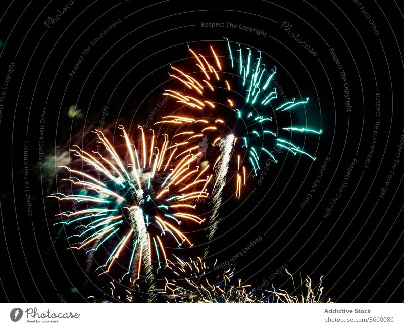 Buntes Feuerwerk auf dunklem Hintergrund blitzen glühen leuchten Nacht Himmel dunkel farbenfroh mehrfarbig pulsierend feiern Großstadt Veranstaltung Dämmerung