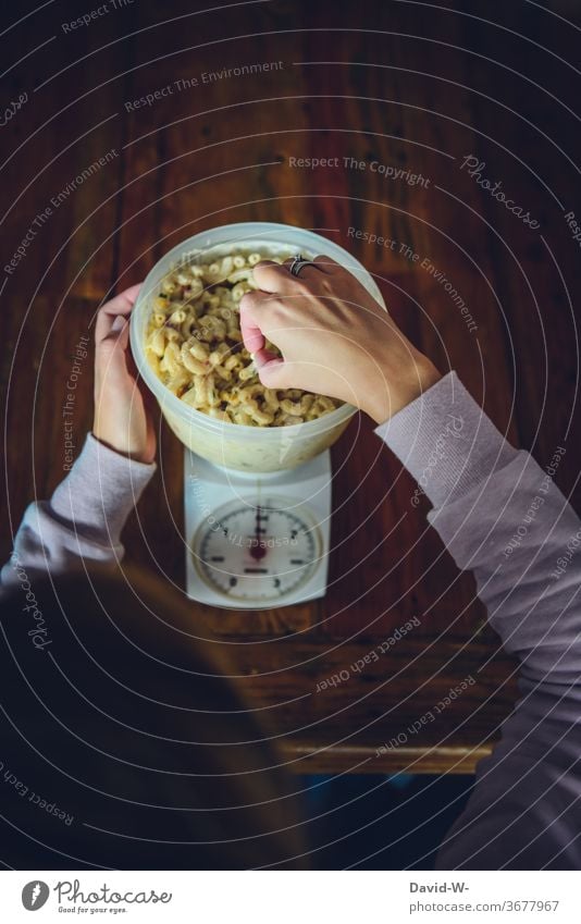 Frau wiegt Nahrungsmittel genau aus Waage auswiegen Messen Kontrolle Hände Schüssel Ernährung Tisch gewichtskontrolle Gewicht messen