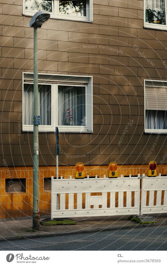 baustelle Baustelle Haus Straße Straßenlaterne Absperrung trist braun gelb Fenster Fassade Menschenleer