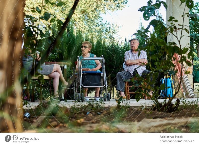 Gruppe von älteren Menschen sitzen auf der Terrasse des Hauses Senior Großeltern sich[Akk] sammeln Hof Zusammensein alt Mundschutz Coronavirus behüten COVID