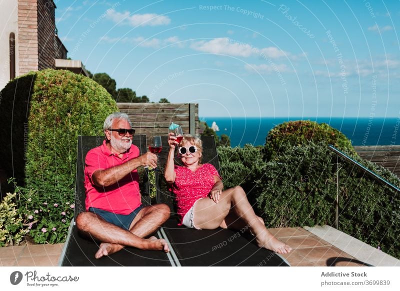 Zufriedenes älteres Paar auf Liegestühlen Sommer Urlaub Cocktail tropisch Senior sich[Akk] entspannen Zusammensein Liegestuhl Lügen Terrasse Getränk Kälte