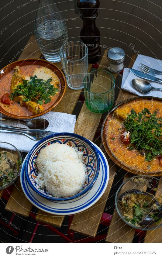 Gedeckter Tisch auf dem Balkon mit leckerem indischen Curry und Reis gedeckter Tisch orientalisch draußen Essen Ernährung Häusliches Leben Abendessen