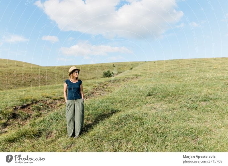 Junge Frau genießt auf den Bergwiesen Erwachsener sorgenfrei lässig Kaukasier heiter Landschaft genießen Umwelt erkunden Feld Freiheit Gras grün Fröhlichkeit