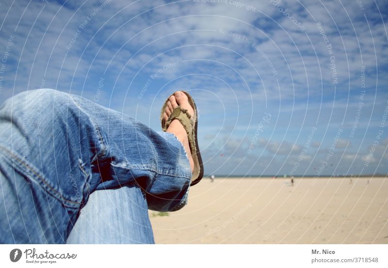 abhängen am strand Strand Blauer Himmel Wolken Jeanshose blue jeans Flipflops lässig Erholung blau Bekleidung Mode Material Jeansstoff Beach liegen Fuß Beine