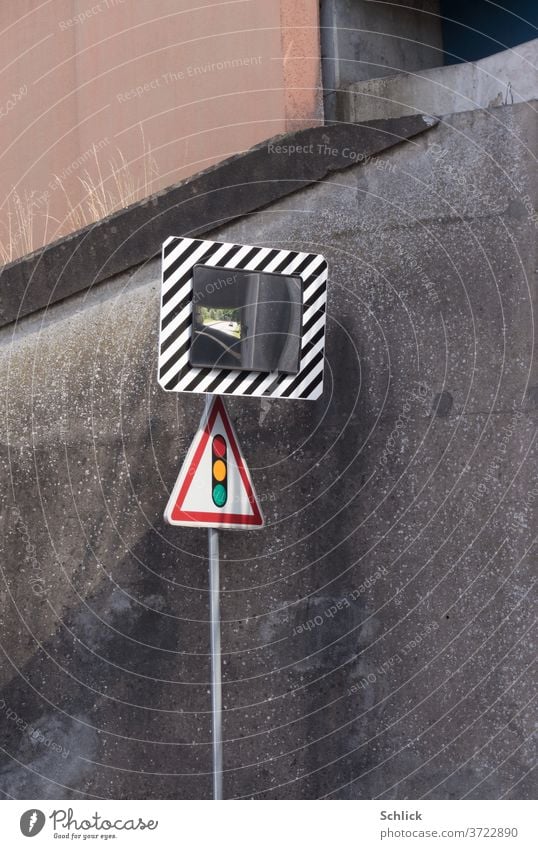 Verkehrsspiegel und Verkehrszeichen Ampel vor Betonwand einer Unterführung Spiegel Konvexspiegel Auto Spiegelung winzig Gräser Streiflicht Straßenverkehr