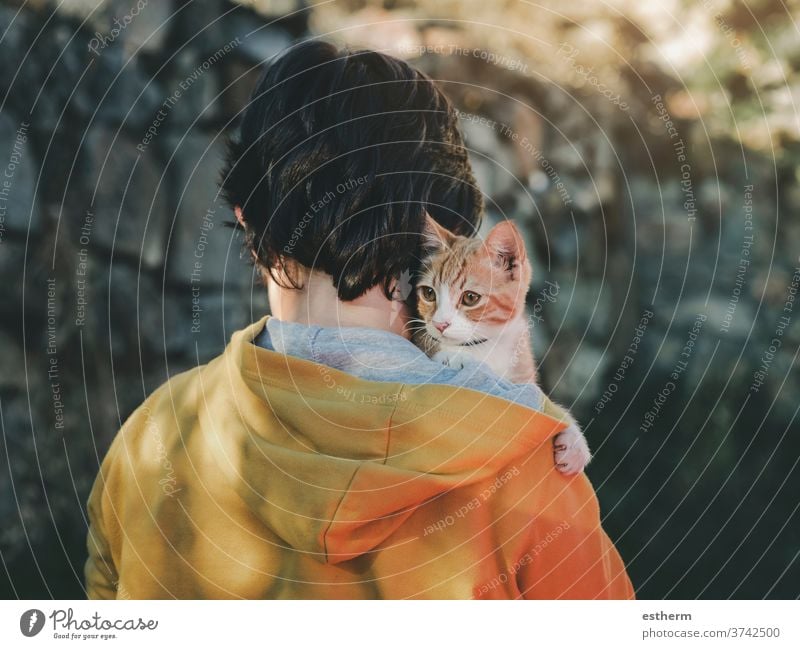 Rückenansicht eines Kindes mit Kätzchen Katzenbaby Haustier Haustiere Liebe heimisch Irrläufer heimatlos bezaubernd Menschen Kleinkind Baby verirrt im Freien