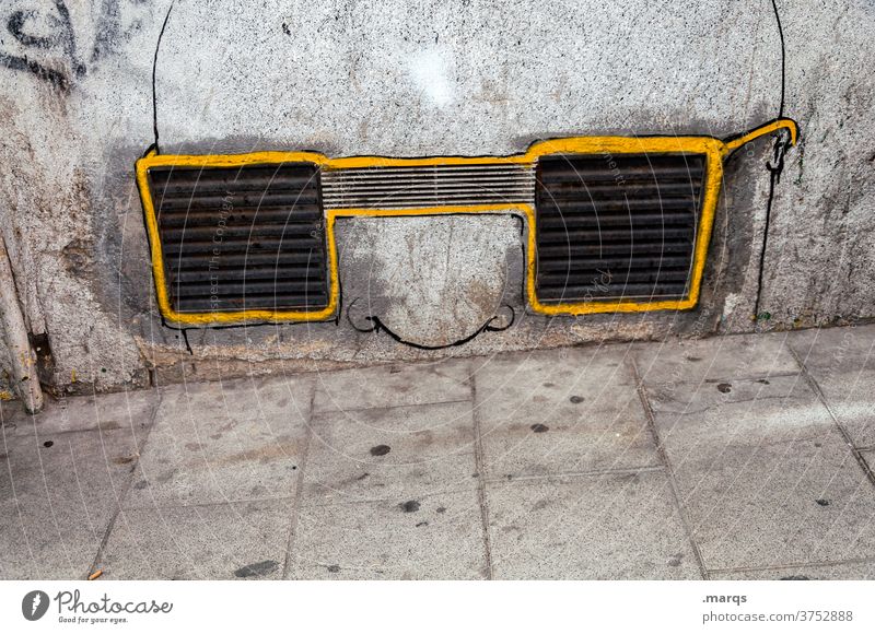 Kunst am Bau | stiller Beobachter Wand Beton Mauer grau Lüftungsschlitz Lüftungsschacht Graffiti skurril Brille Brillenträger Nase beobachten Überwachung gelb