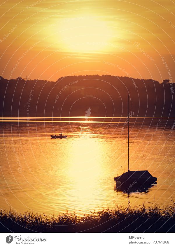 entspannung am see angler boot Sonnenuntergang Sonnenlicht Abendsonne Segelboot Seeufer Gewässer Ruderboot Urlaubsstimmung Sommer Ruhe allein Natur Angler