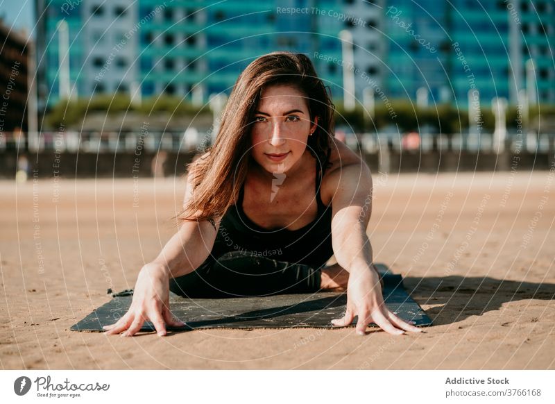 Zufriedene Frau beim Yoga Vorwärtsbeuge beweglich Dehnung Unterlage sich[Akk] entspannen Janu Sirsasana Pose Asana positionieren Strand Gesundheit Sommer