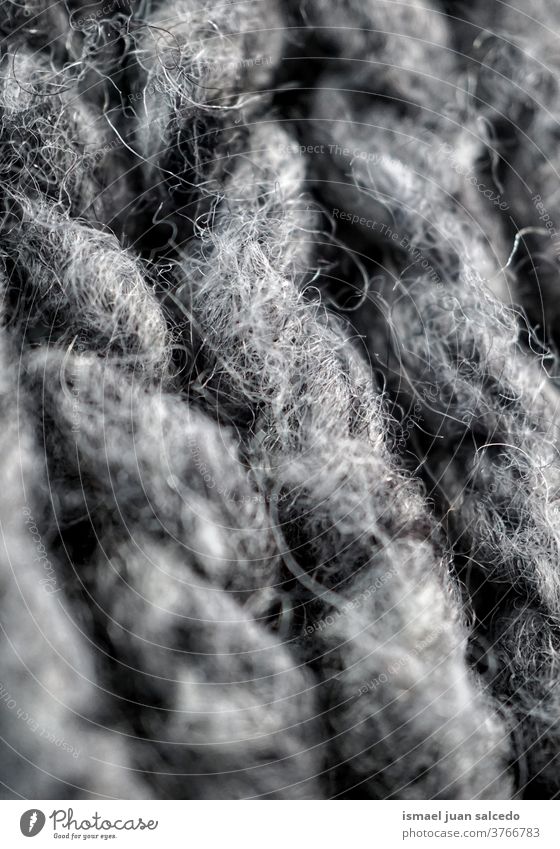graue Wolle, Tuch handgefertigt Faser Gewebe Stoff texturiert abstrakt Hintergrund Muster Material Industrie Textil Design Detailaufnahme Makro stricken