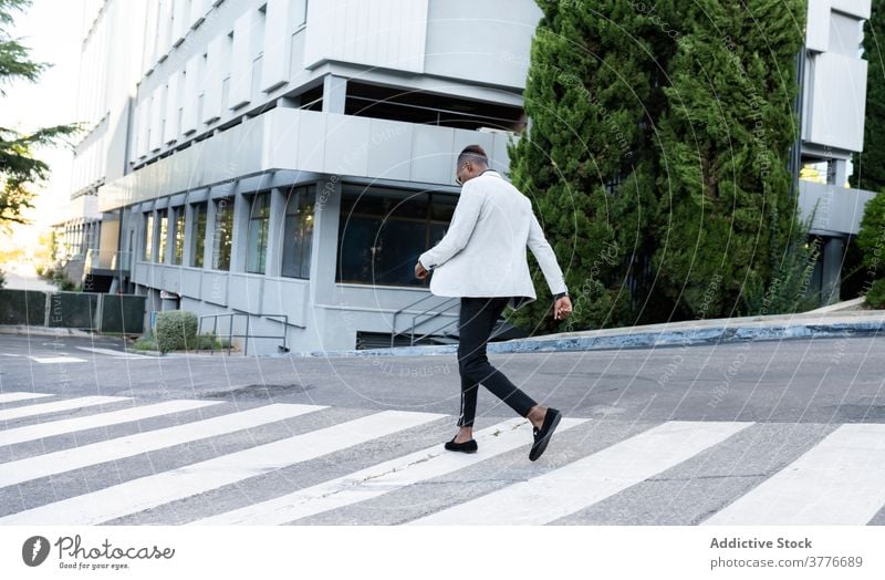 Stilvolle schwarze Geschäftsmann Überquerung der Straße in der Stadt Zebrastreifen Großstadt Unternehmer stilvoll Spaziergang durchkreuzen trendy männlich