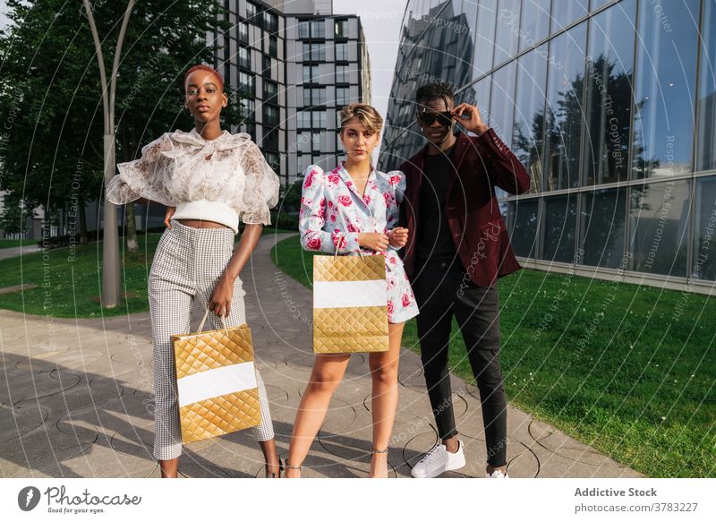 Junge modische Menschen mit Einkaufstaschen auf der Straße Mode Stil Menschengruppe trendy Outfit urban Käufer Kunde selbstbewusst Zeitgenosse Zusammensein