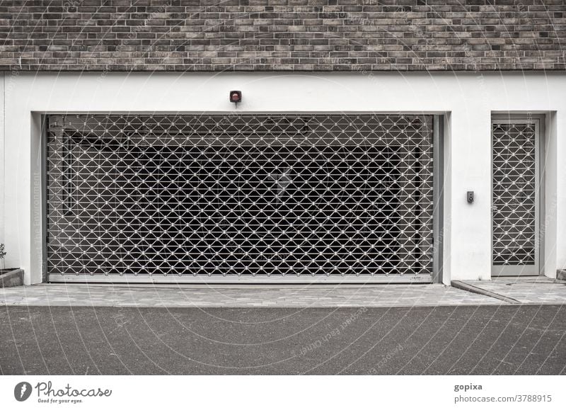 Einfahrt einer Tiefgarage parken Sicherheit Schutz Garage Geheimnis geschlossen geschützt Gitter hässlich sicher Beton anonym Anonymität Architektur Stillstand