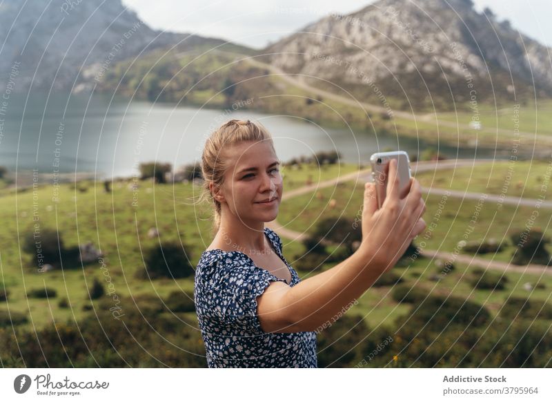 Frau, die selfie mit spektakulären Berge Tal auf Hintergrund Hochland fotografieren Smartphone Berge u. Gebirge erstaunlich Landschaft Gedächtnis Moment Telefon