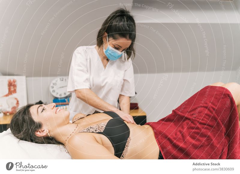 Weibliche Therapeutin massiert Bauch der Frau im Krankenhaus Rehabilitation Massage Therapie Leckerbissen Magen medizinisch geduldig Pflege Gesundheitswesen