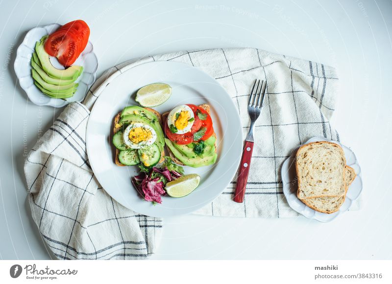 gesundes vegetarisches Frühstück, Avocado-Toast mit Gurke, Eiern, Tomate und griechischem Salat auf Vollkornbrot Mahlzeit Lebensmittel Zuprosten Mittagessen