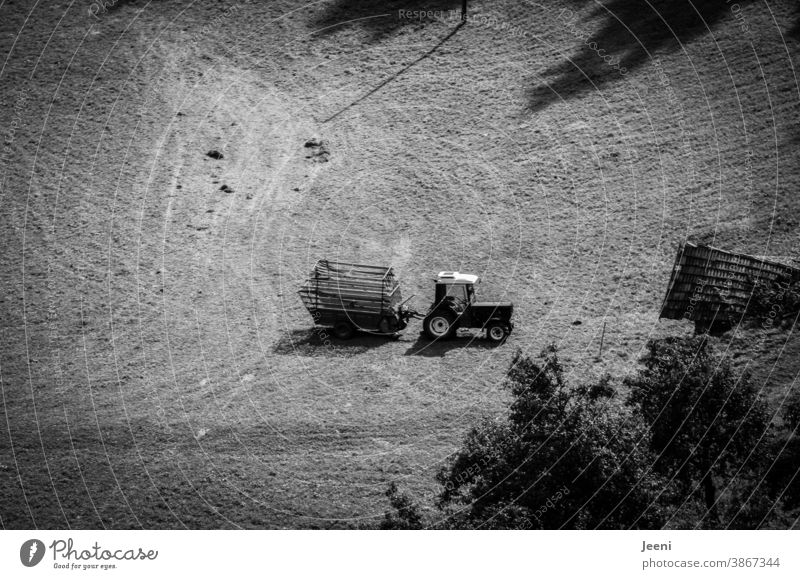 Kleiner Traktor mit Anhänger auf einer Almwiese in den Bergen aus der Vogelperspektive Trecker Alpen von oben klein Berge u. Gebirge Berghang Wiese wandern