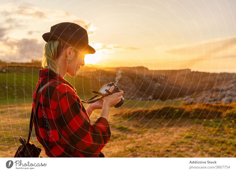 Fotograf auf Hügel bei Sonnenuntergang reisen Frau Reisender Fotoapparat erkunden Abenteuer androgyn alternativ Geschlecht professionell Natur Fotokamera Gegend