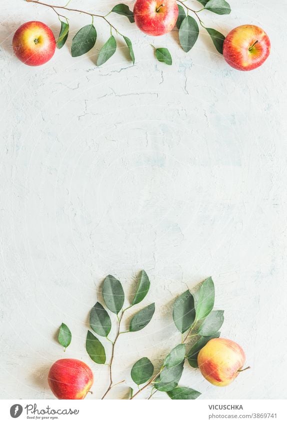 Rahmen aus Äpfeln mit grünen Blättern auf weißem Hintergrund. Ansicht von oben Apfelbaum Zweige Muster Draufsicht süß flach Tisch Layout Frische reif