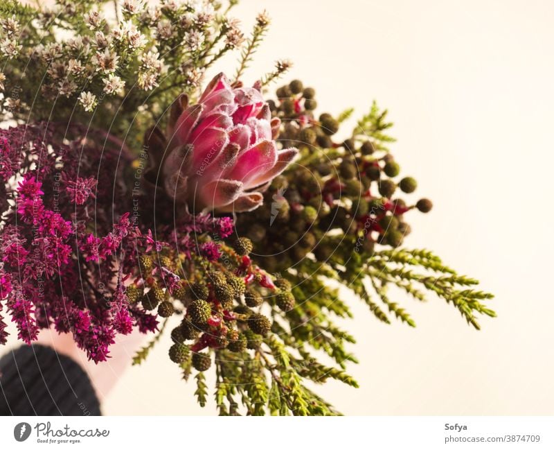 Wunderschöner Herbstblumenstrauß in weiblicher Hand. Blume Hintergrund Blumenstrauß rosa Protea Feld geblümt Winter Haufen gemischt wild Frühling Natur Frau