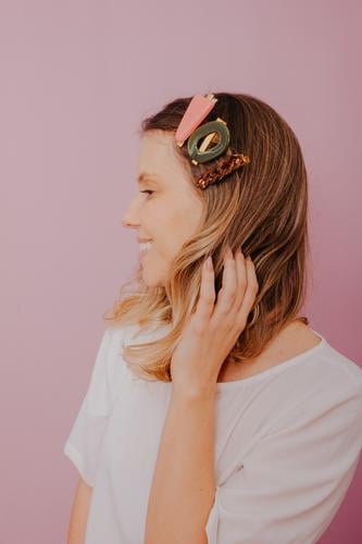 Blonde Frau mit Clips im Haar, moderne Haarnadeln, rosa Hintergrund Zubehör blond Nahaufnahme Textfreiraum redaktionell Mode Modefotografie Modenschau modisch