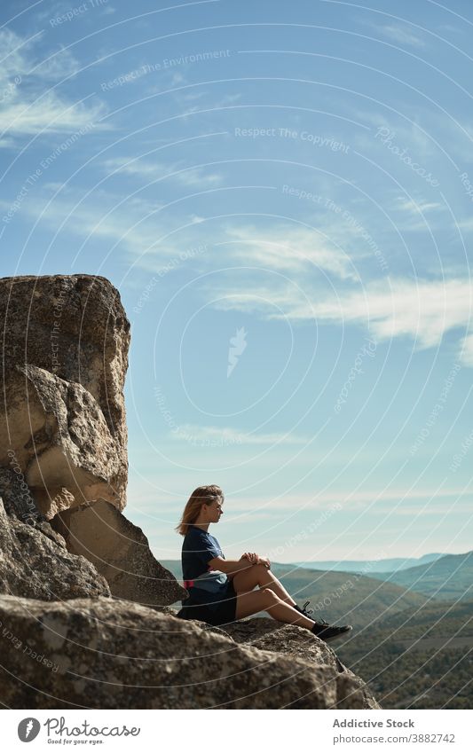 Reisende Frau sitzt auf einem Felsen im Hochland Wanderer Berge u. Gebirge Trekking Aussichtspunkt sich[Akk] entspannen Freiheit genießen Hügel felsig Abenteuer